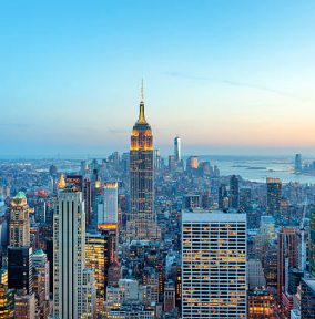 illuminated skyscrapers in Manhattan at evening with Empire State Building and Freedom Tower - the new World Trade Center, New York City