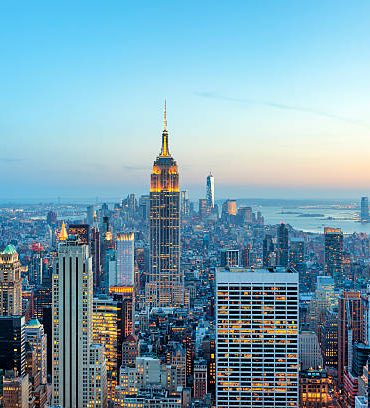 illuminated skyscrapers in Manhattan at evening with Empire State Building and Freedom Tower - the new World Trade Center, New York City