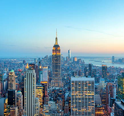 illuminated skyscrapers in Manhattan at evening with Empire State Building and Freedom Tower - the new World Trade Center, New York City